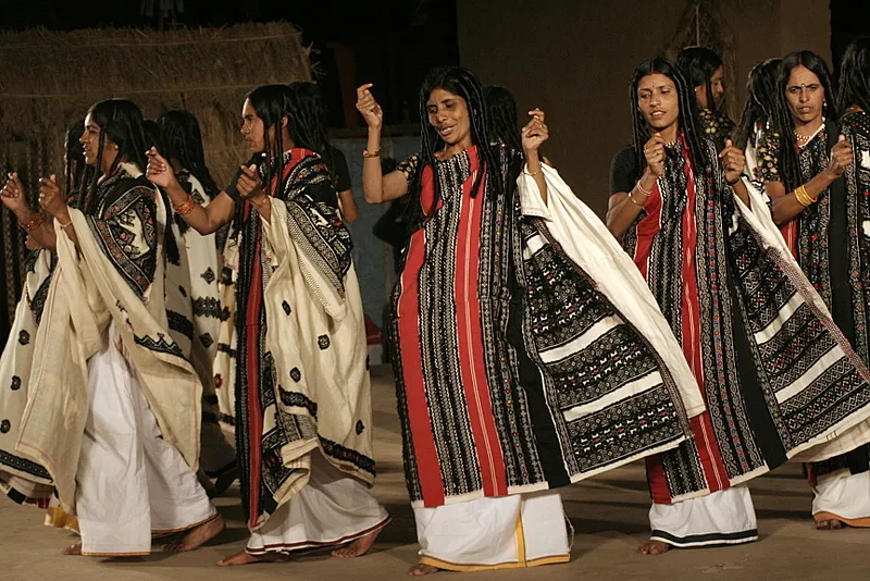Toda women performing a traditional dance, showcasing their rich cultural heritage, vibrant attire, and unique tribal traditions in the Nilgiris.