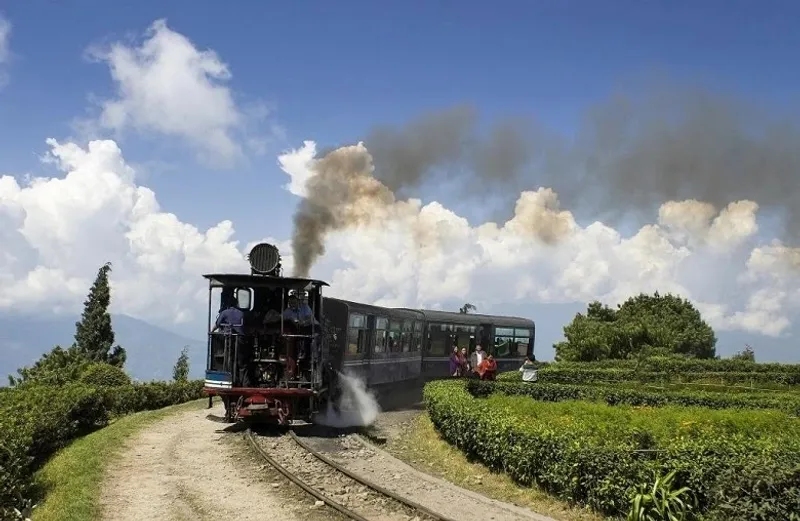 Batasia Loop in Darjeeling, where the iconic toy train gracefully turns around the loop, offering panoramic views of the hills and valleys.